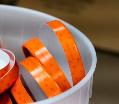 Hokie Tracks pint container lids in a receptacle 