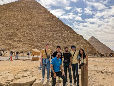 Professor Mohammed Seyam and his students standing in front of pyramids in Egypt