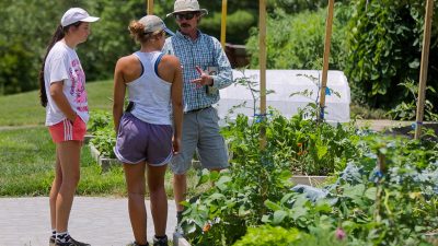 Paul Chumbley (at right), a horticulturist at the Hahn Horticulture Garden, speaks with interns Sarah Cole and Emily Wilson