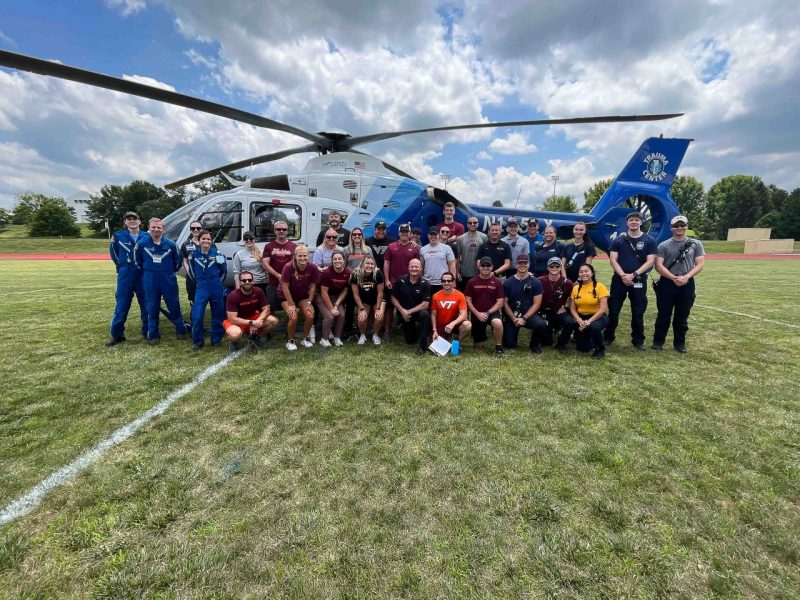 Virginia Tech Rescue Squad members pose in front of Carilion Clinic Lifeguard Helicopter with other first responders in the county
