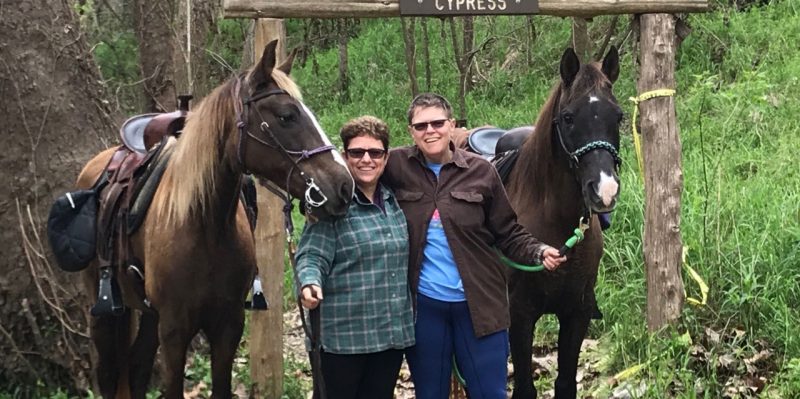 (left to right) Lianne Lami with wife Denise Hamby and their horses.