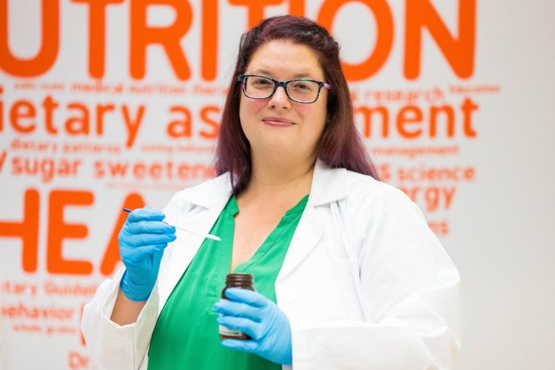 Valisa Hedrick measures out a non-sugar sweetener dose for research subjects participating in an intervention trial looking at the impact of their intake on glucose and insulin levels.