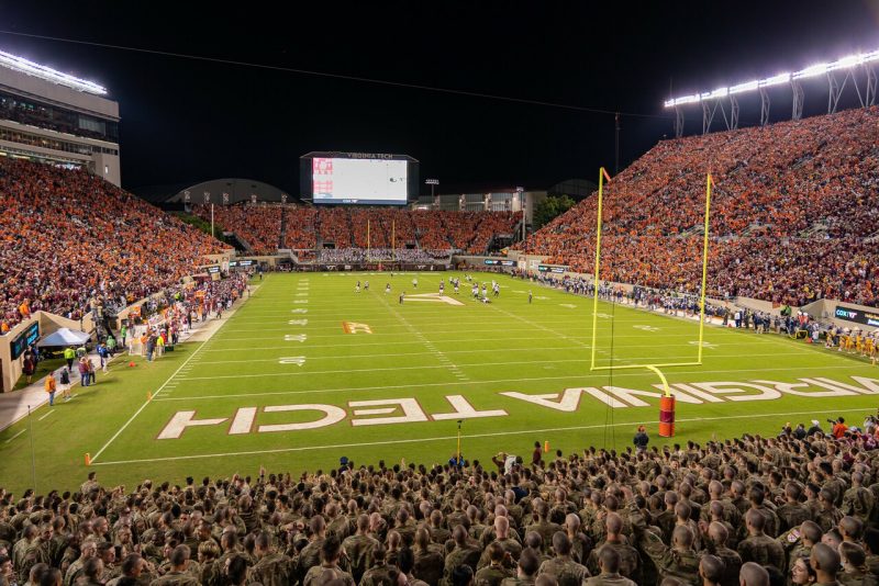 Crowds watch a football game in Lane Stadium