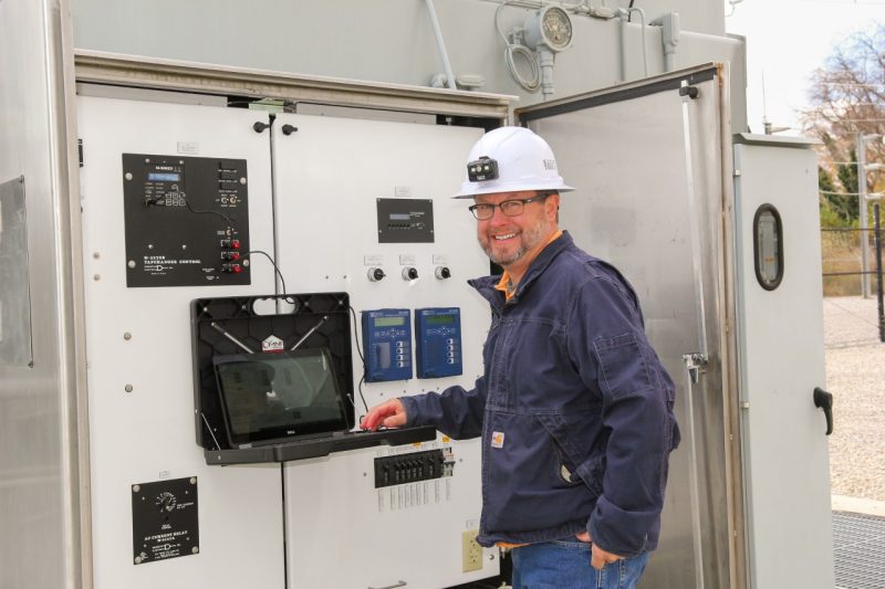 electrical engineer runs software at a power substation