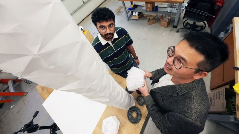 Graduate Researcher Vishrut Deshpande and Suyi Li inspect a plant-inspired robot prototype. Photo by Alex Parrish for Virginia Tech.