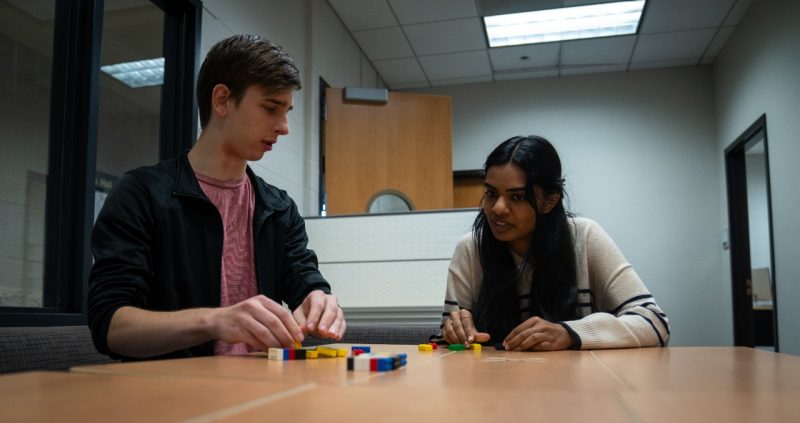 Undergraduates Noah Provenzano (from left) and Namita Shashidhar working on a lego game to teach computer science to elementary students.