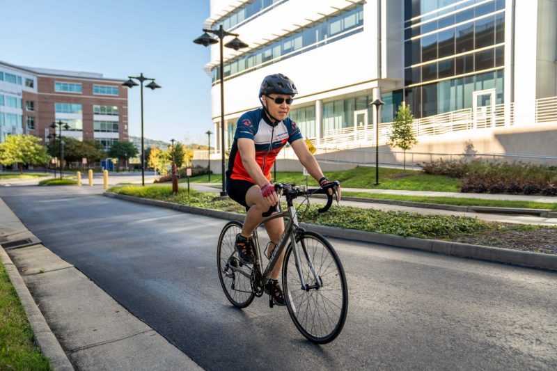 Zhen Yan on a road bike outside the Fralin Biomedical Research Institute at VTC in Roanoke, Virginia