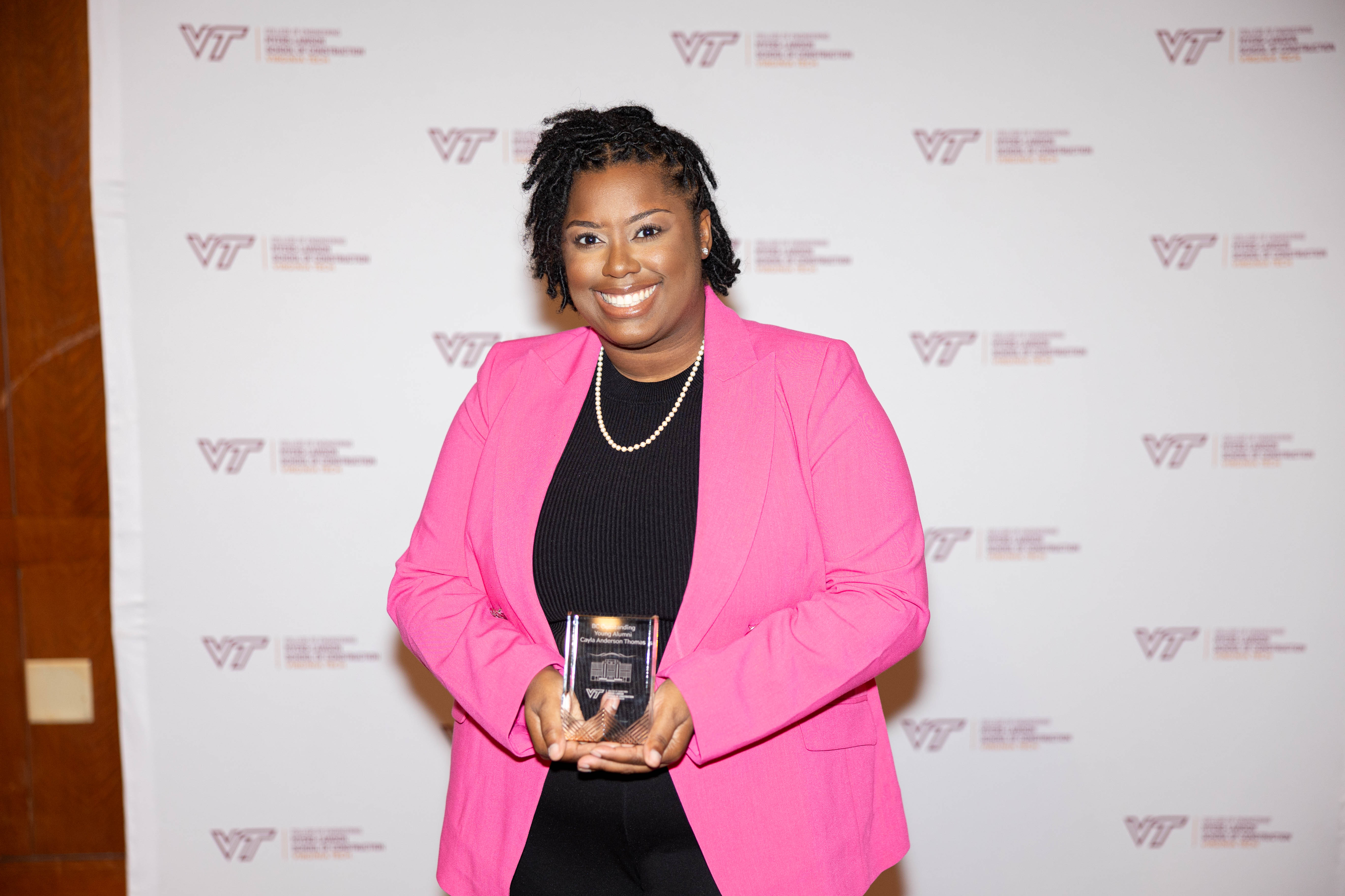 Cayla Thomas '16 with her Outstanding Young Alumni Award. Photo by Will Drew for Virginia Tech.
