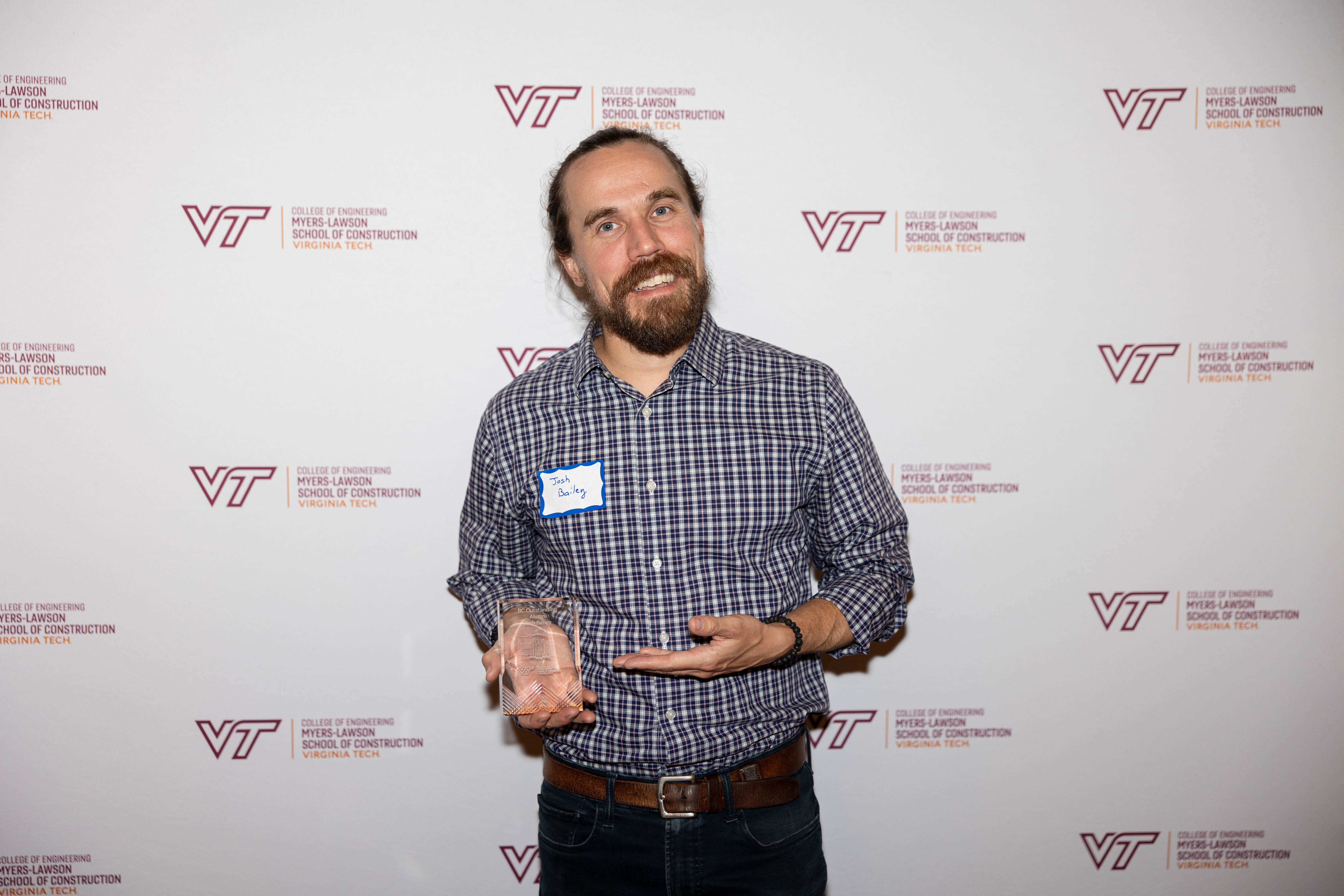 Joshua Bailey '09 with the Outstanding Building Construction Alumnus Award. Photo by Will Drew for Virginia Tech.