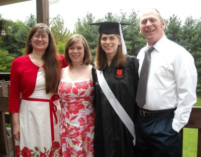 family poses for graduation photo
