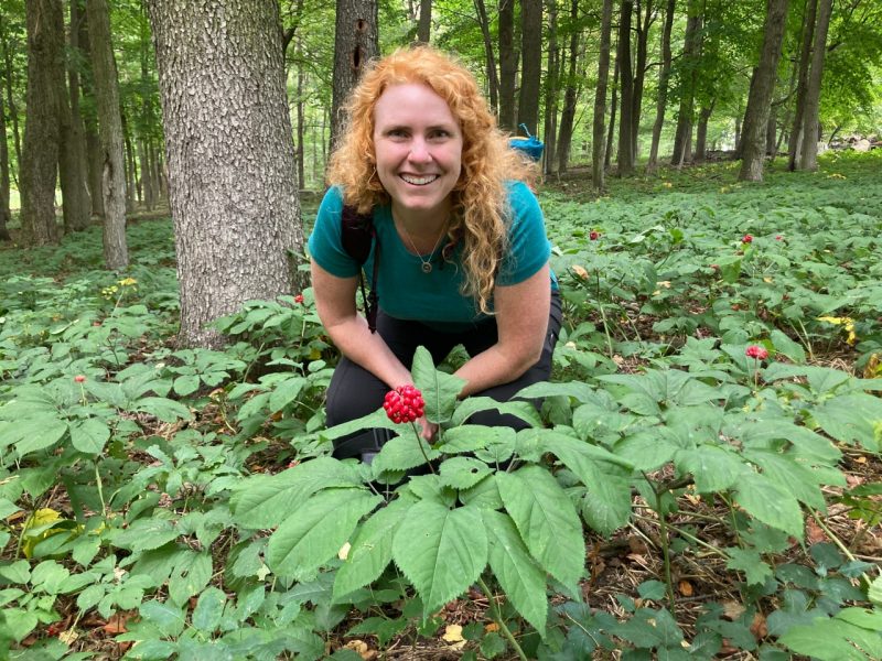 Shannon Bell at Hardings Ginseng Farm, posing with growing ginseng. 