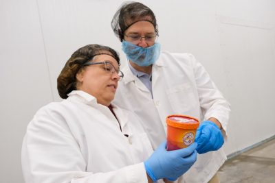 Joell Eifert and Brian Wiersema inspect a pint container of Hokie Sunset Swirl