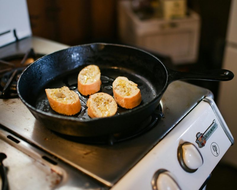 Bread cooking in a cast iron pan on the stove