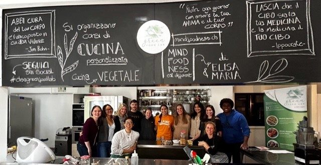 A group of people in a large kitchen.