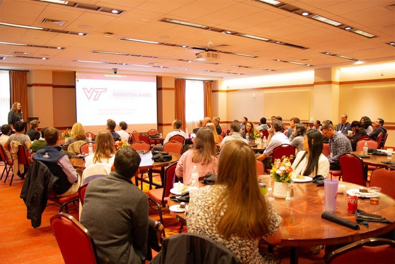 group sitting at tables looking at speaker