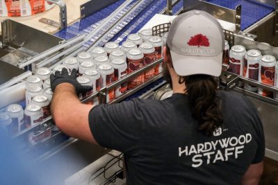 A Hardywood employee checks on dozens of cans on the production line