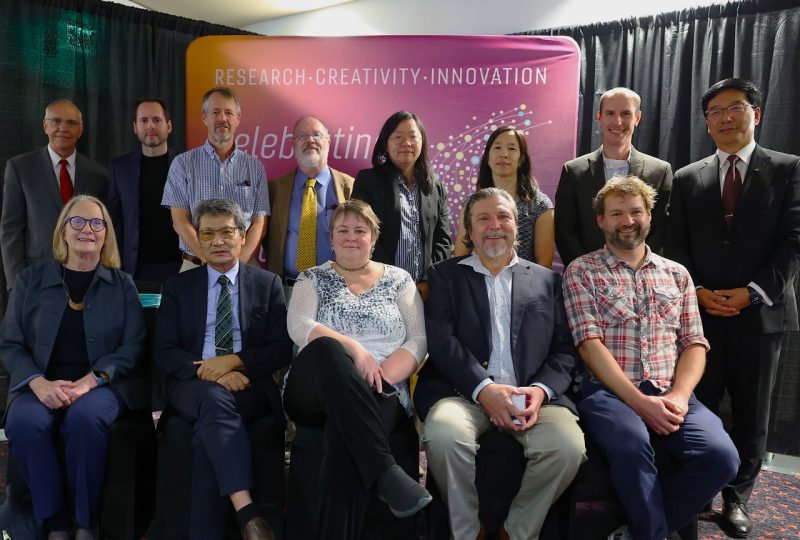 a group of people posing for a photo after winning awards.