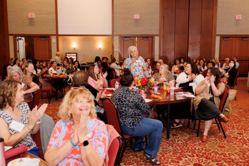 One Early Childhood Champions Award nominee, Melanie Brusseau (at center, standing) receives an ovation at the Igniting Connections Symposium held at The Inn at Virginia Tech. 