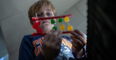 There aren’t many ways to explain something as complex as DNA sequencing to kids. However, using candies to show how each component of the DNA chain connects sparks their curiosity. Photo by Rodney Kimbangu for Virginia Tech.