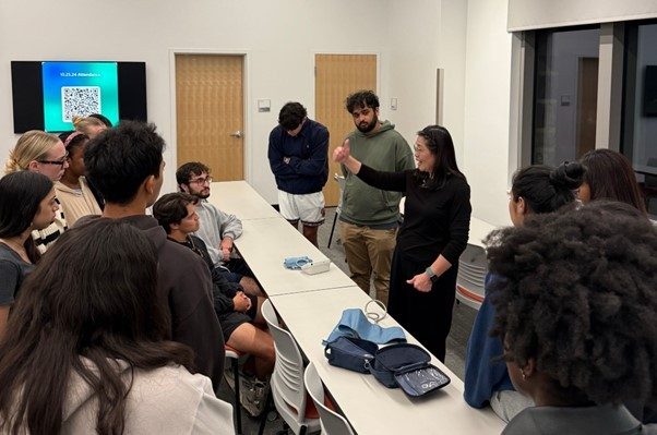 Li-Li (at center) is demonstrating how to use equipment with students.