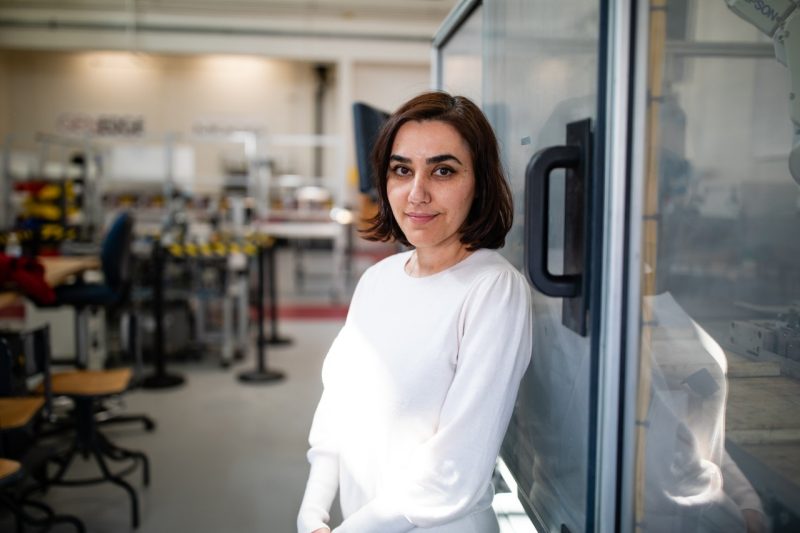 A woman stands in her lab space.