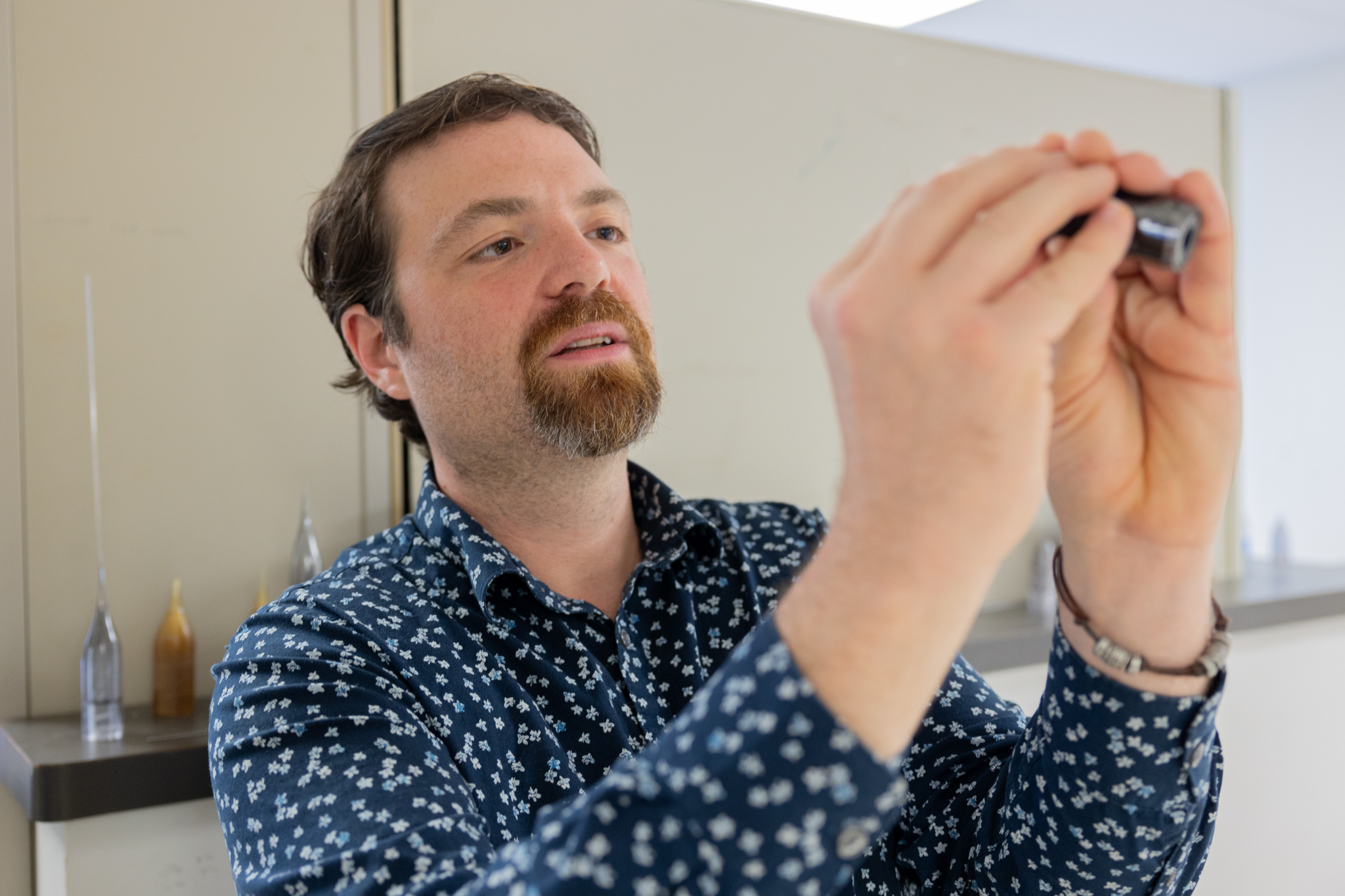 Researcher examines brain probe.