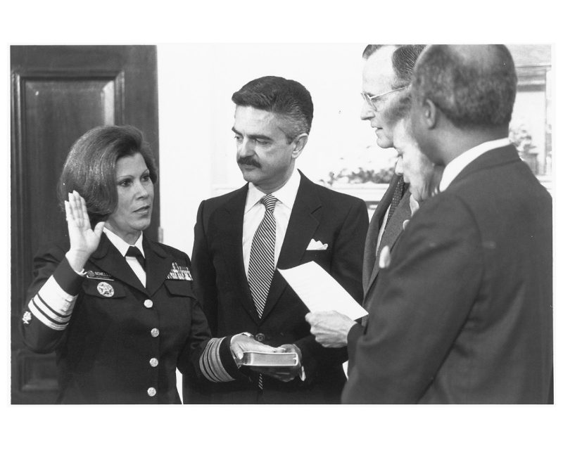  Antonia C. Novello has her hand on the Bible and hand raised during her swearing in.