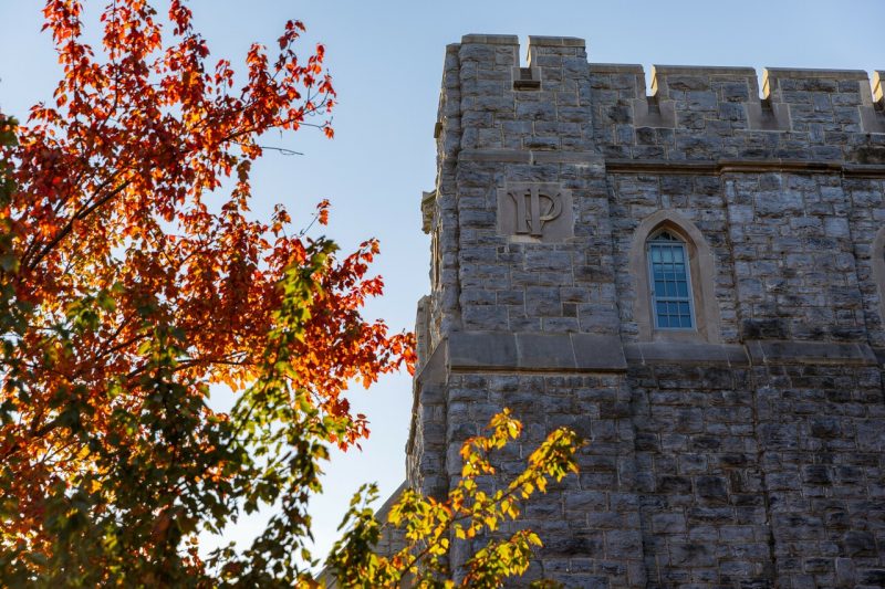 Burruss Hall and a fall tree.