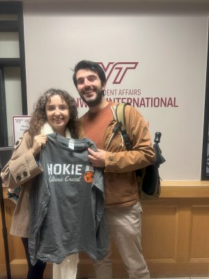 Two students hold up a Hokie Culture Crawl shirt