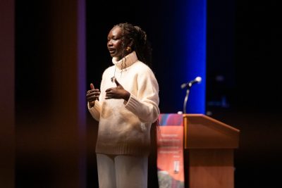 Mary Maker speaks on the stage in the Moss Arts Theater