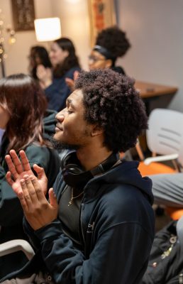 person clapping in an audience