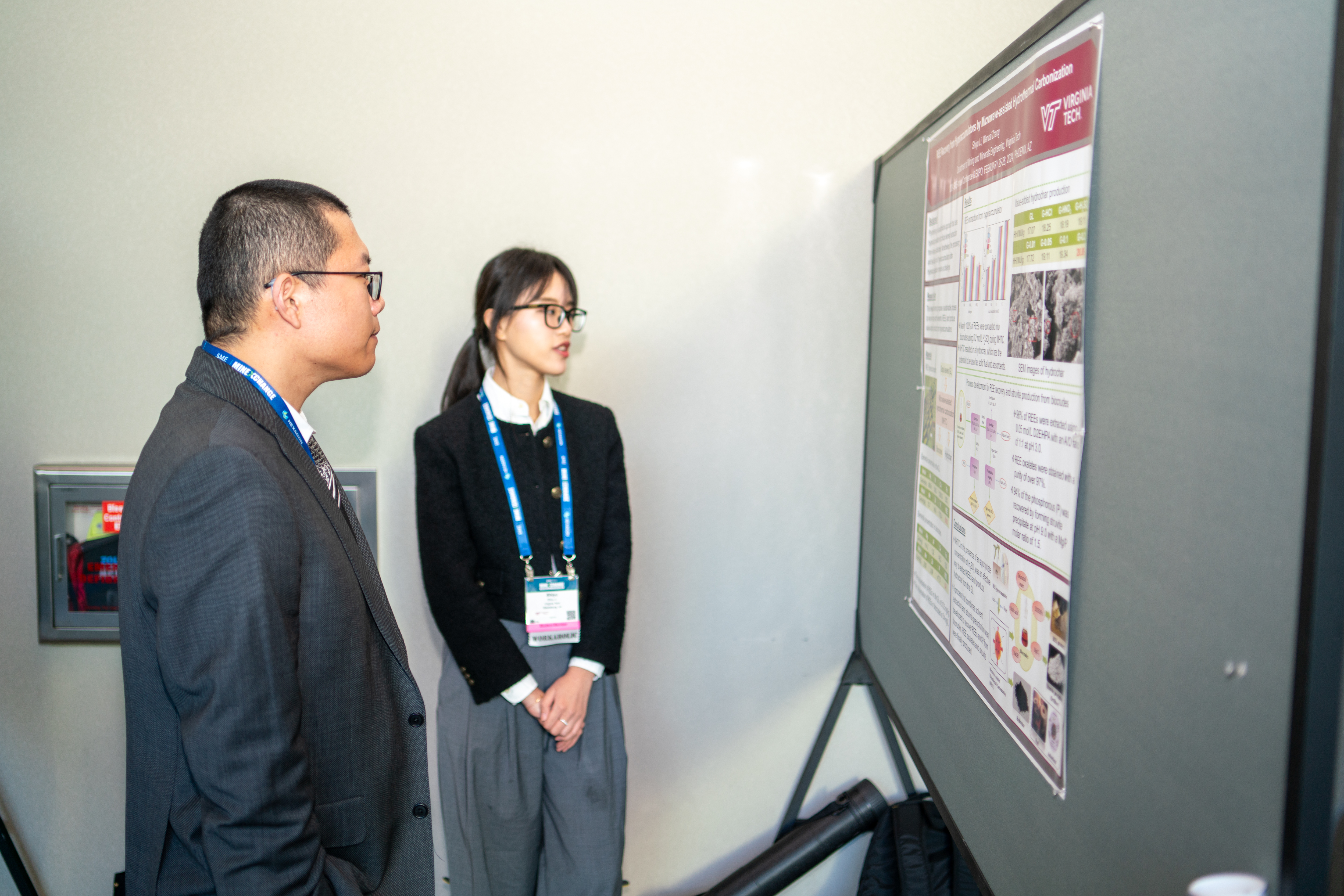 Two students looking at a research poster.