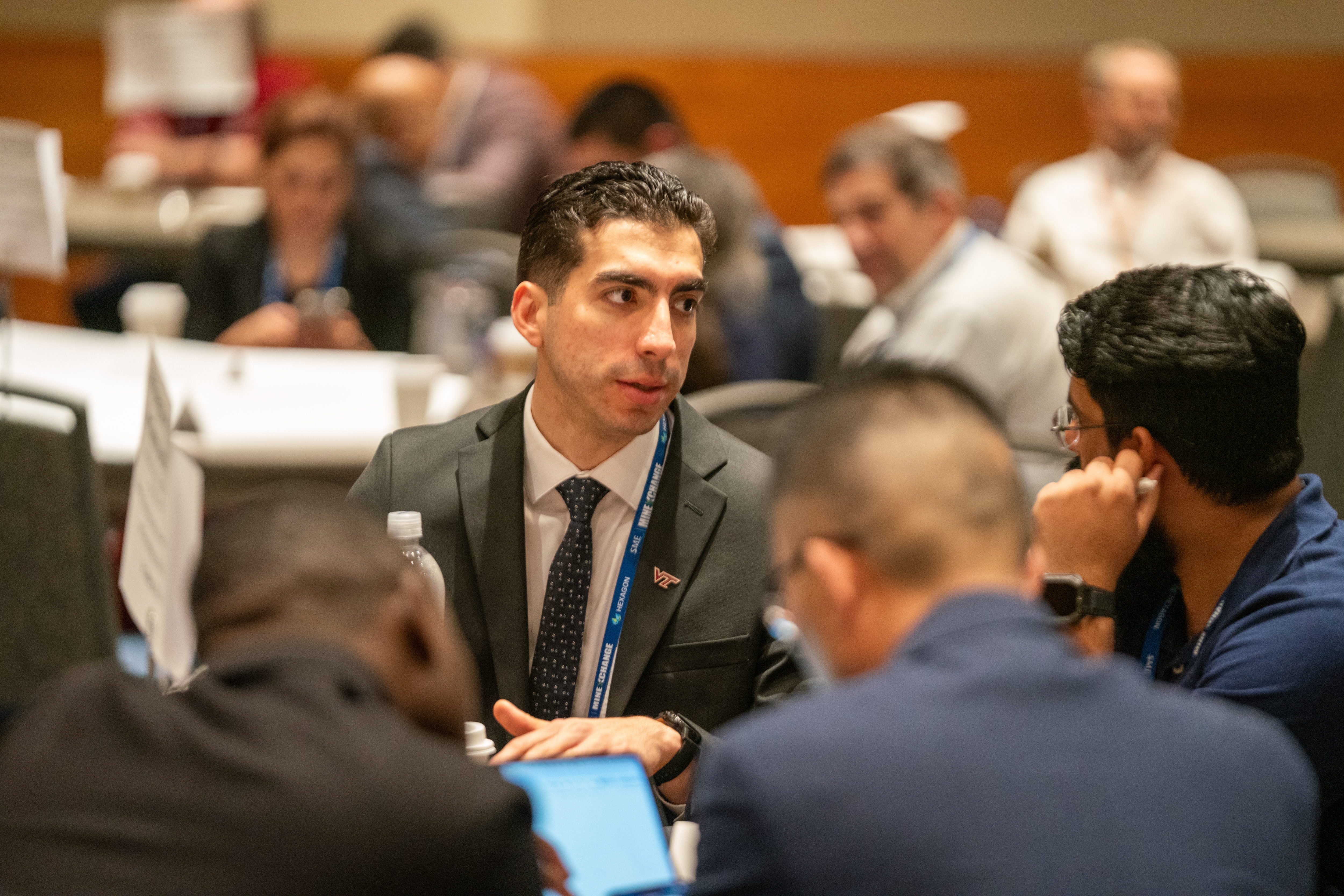 Graduate student Nestor Santa sitting at the conference.