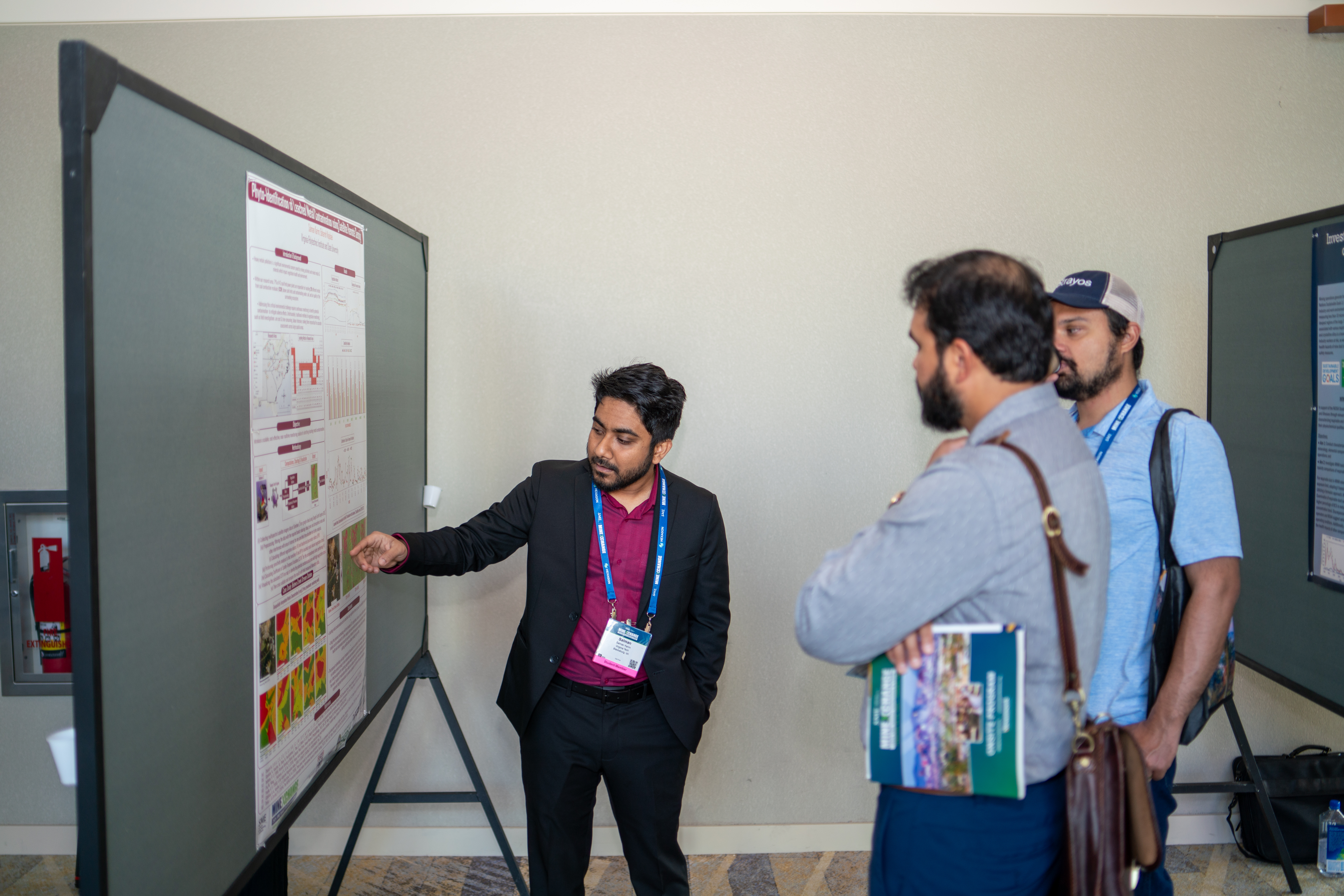 Student Salman Karim presenting his poster to other attendees. 