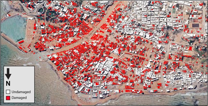 Google Earth image of buildings in the Wadi Derna River Valley. A large number of them are color-coded red.