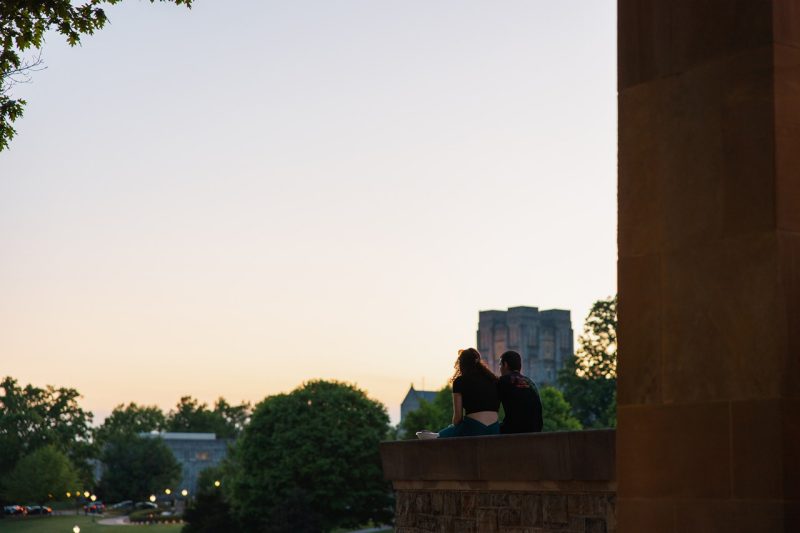 Two people sit at the Pylons on sunset. 