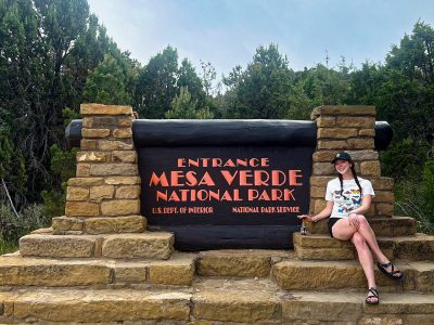 Mary Grace Larson at the entrance of Mesa Verde National Park. Photo courtesy of Mary Grace Larson