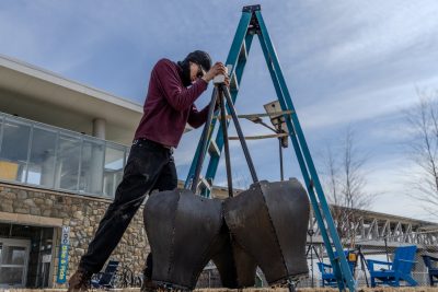 Braden Perryman prepares the structural of Emergence and begins the installation. Photo by Trevor Finney for Virginia Tech.