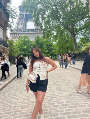During her study abroad experience, Karla Garibay poses in front of the Eifel Tower
