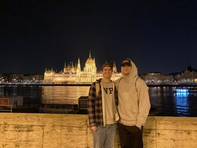 Nathan Brown poses in front of the Hungarian Parliament Building with his brother in Budapest, Hungary