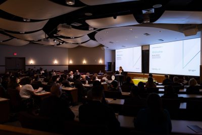 Attendees seated in the Holtzman Alumni auditorium.