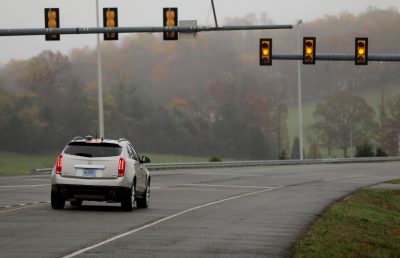 mid size vehicle slows at yellow stoplight