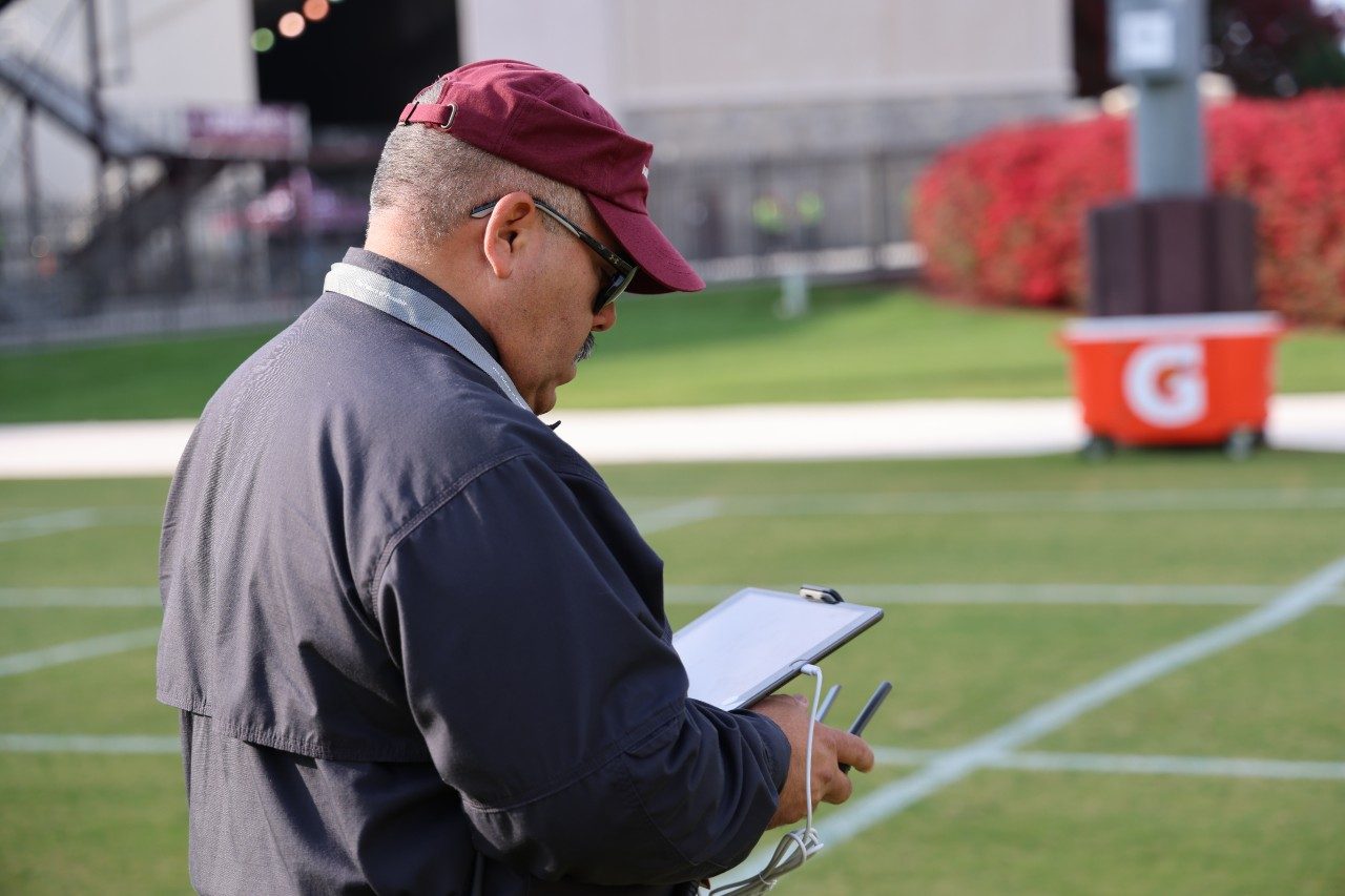 Elvis Rosario flying one of the drones around Lane Stadium.