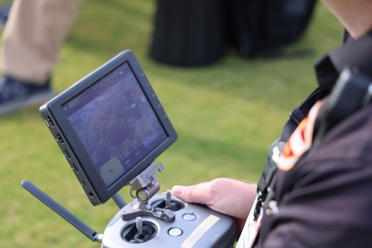 A drone operator with Virginia Tech's Emergency Management overlooking areas surrounding Lane Stadium.