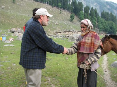 Bruce Bowman shaking hands with a local in Kashmir, India.