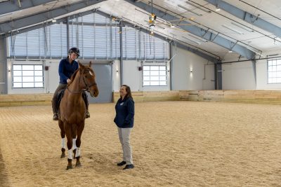 Hannah Schofield rides her horse Merry under the watchful eye of Jennifer Barrett, Theodor Ayer Randolph professor of equine surgery during a soundness evaluation.