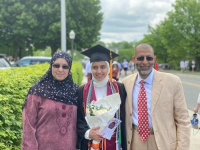 Fawzy Elnady (at right) standing with his wife and daughter who is in graduation attire