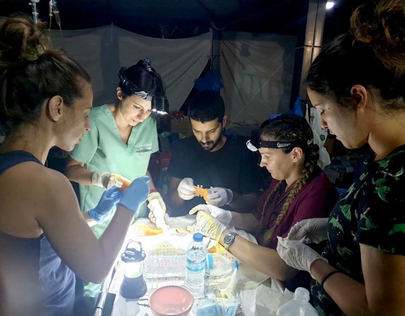 Anna Katogiritis (second from left) works with her team by lamplight in Greece.