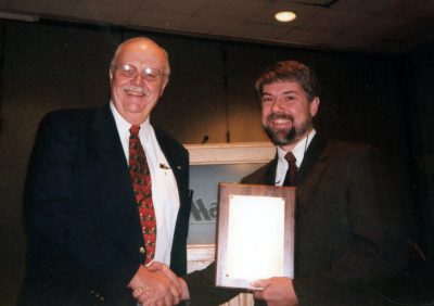 Greg Daniel receiving an award.