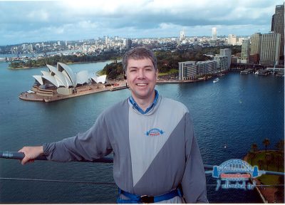 Greg Daniel posing with the Sydney, Australia cityscape behind him.